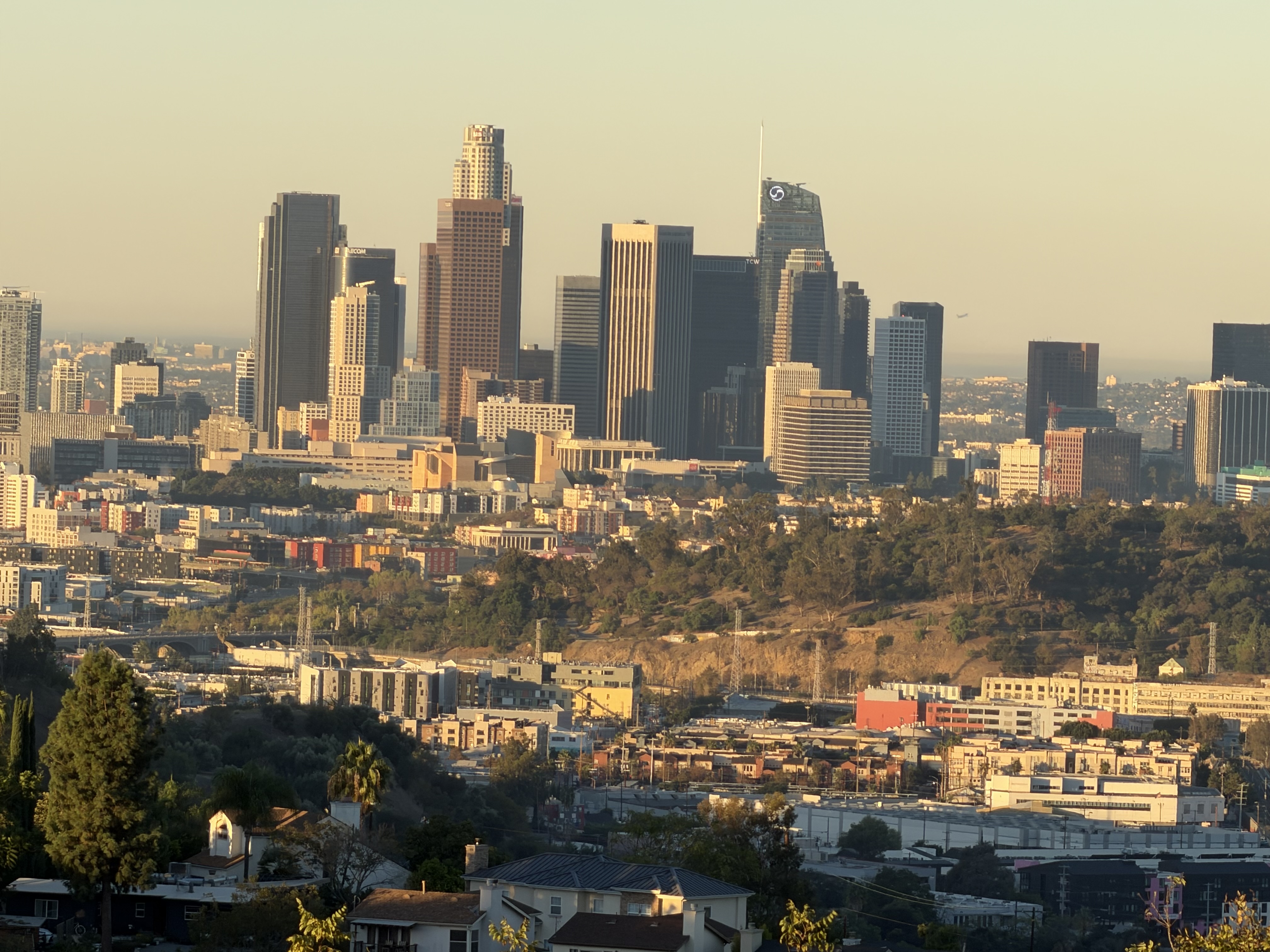 The Los Angeles skyline is illuminated by the morning sun about half an hour after sunset.