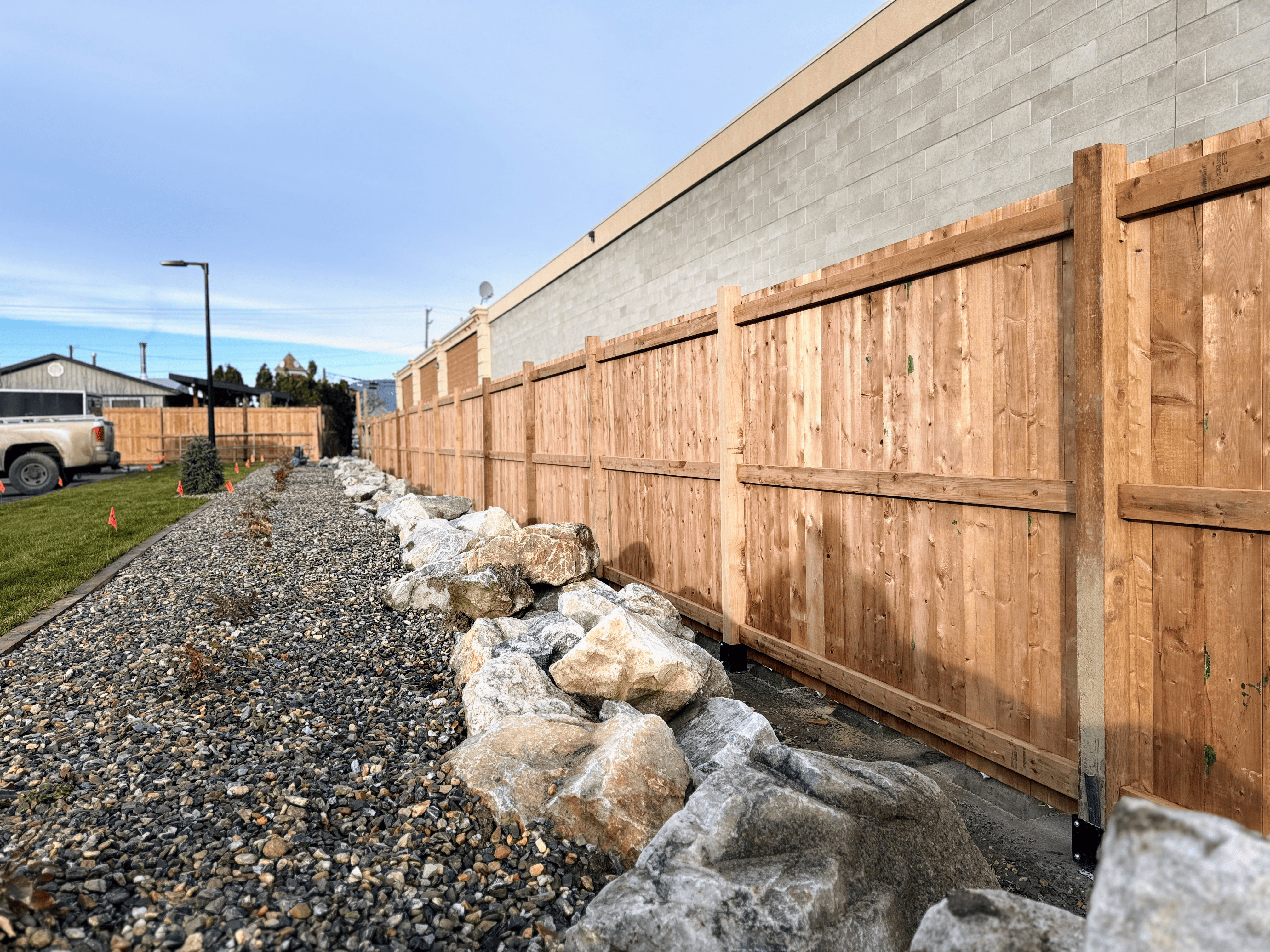 Vertical cedar privacy fence installation for residential property boundary in Salmon Arm.