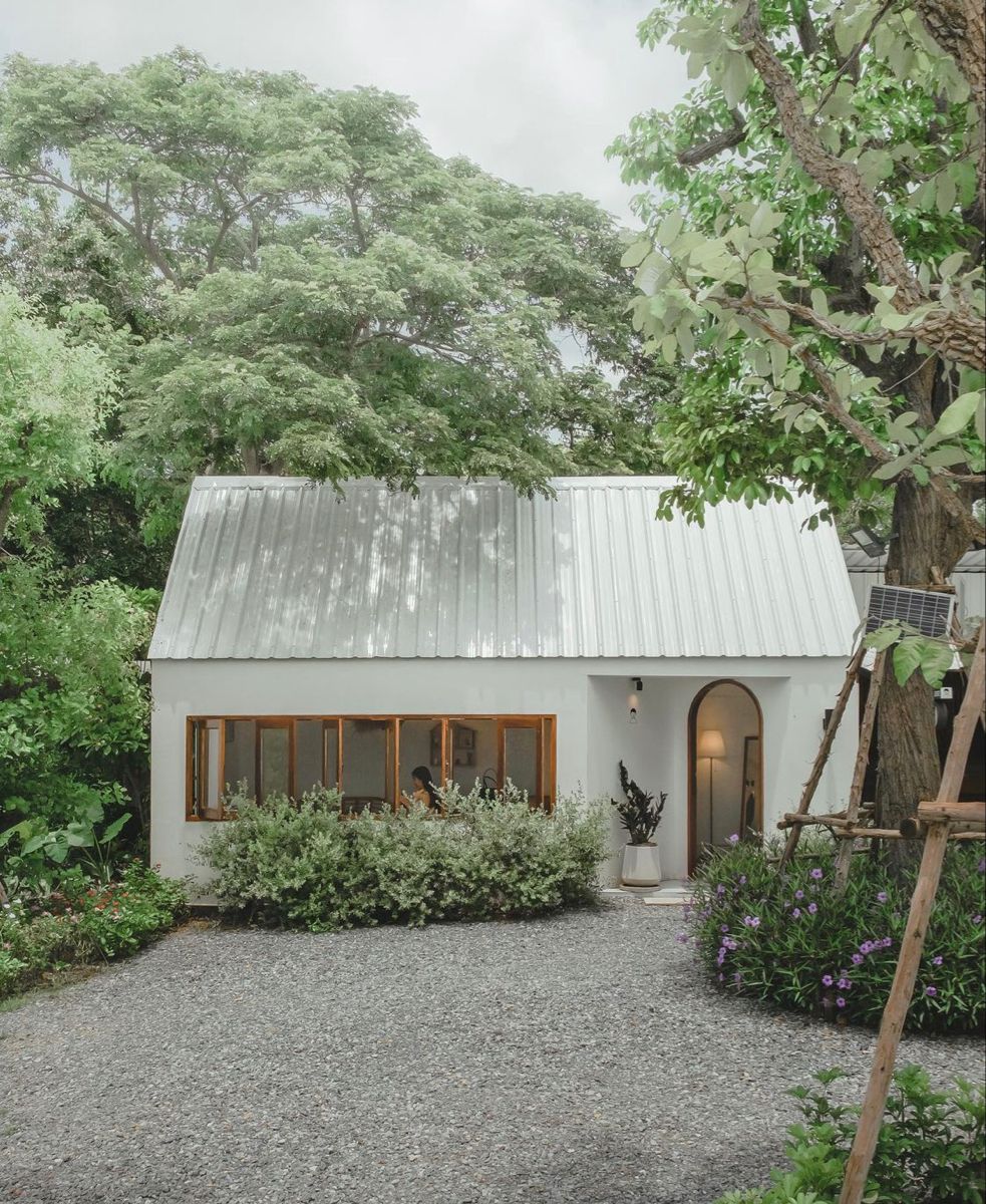 white garden shed surrounded by trees