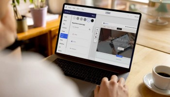 A person at a laptop adding Smart Apps to their Jimdo website.