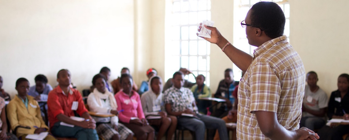 Duncan Ogendi Oginda demonstrates how to check if a female condom has expired or not.