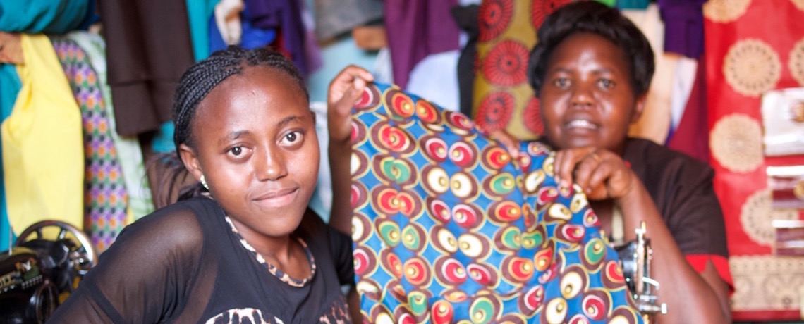 Dorcas shows off a dress she made at her tailoring attachment.