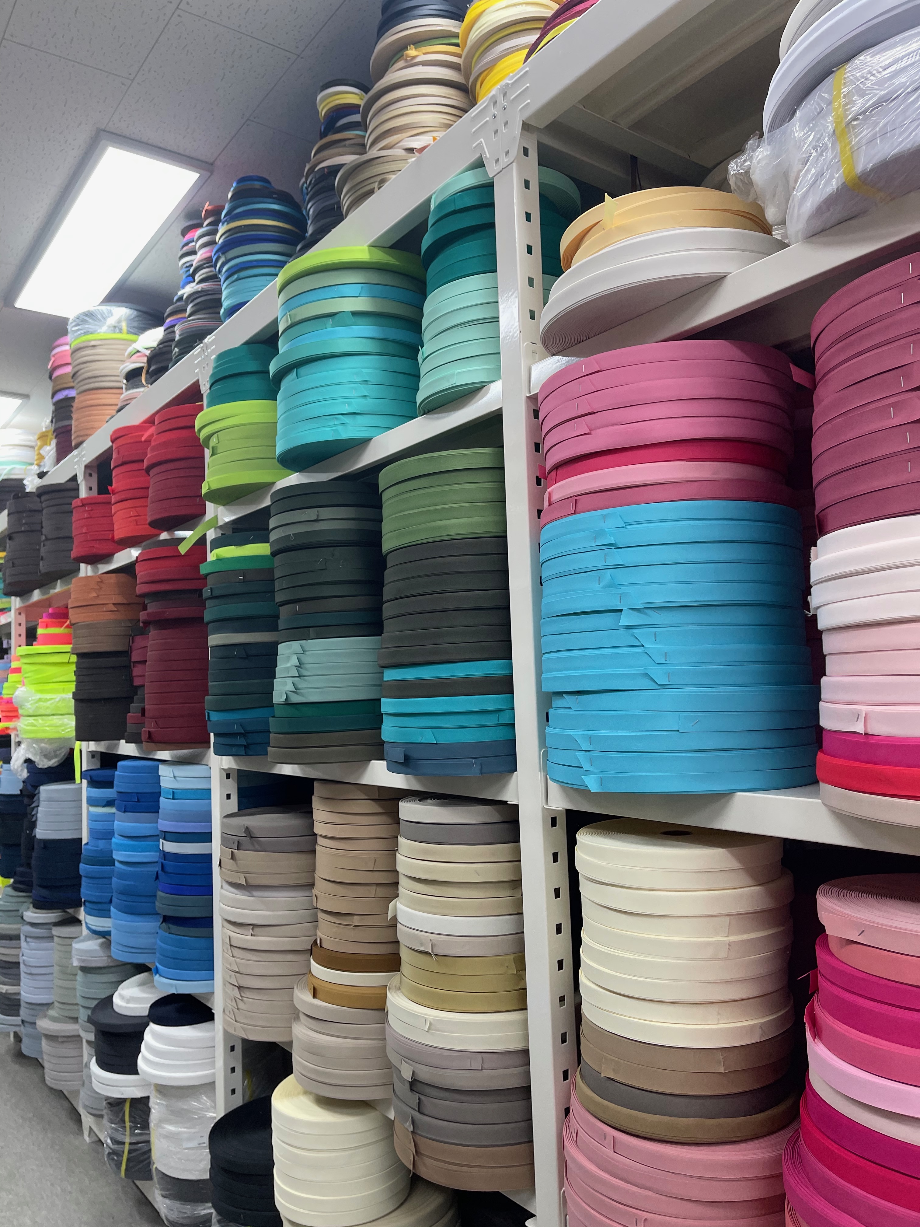 Weaving and trim rolls on shelves in Sinseol-dong market