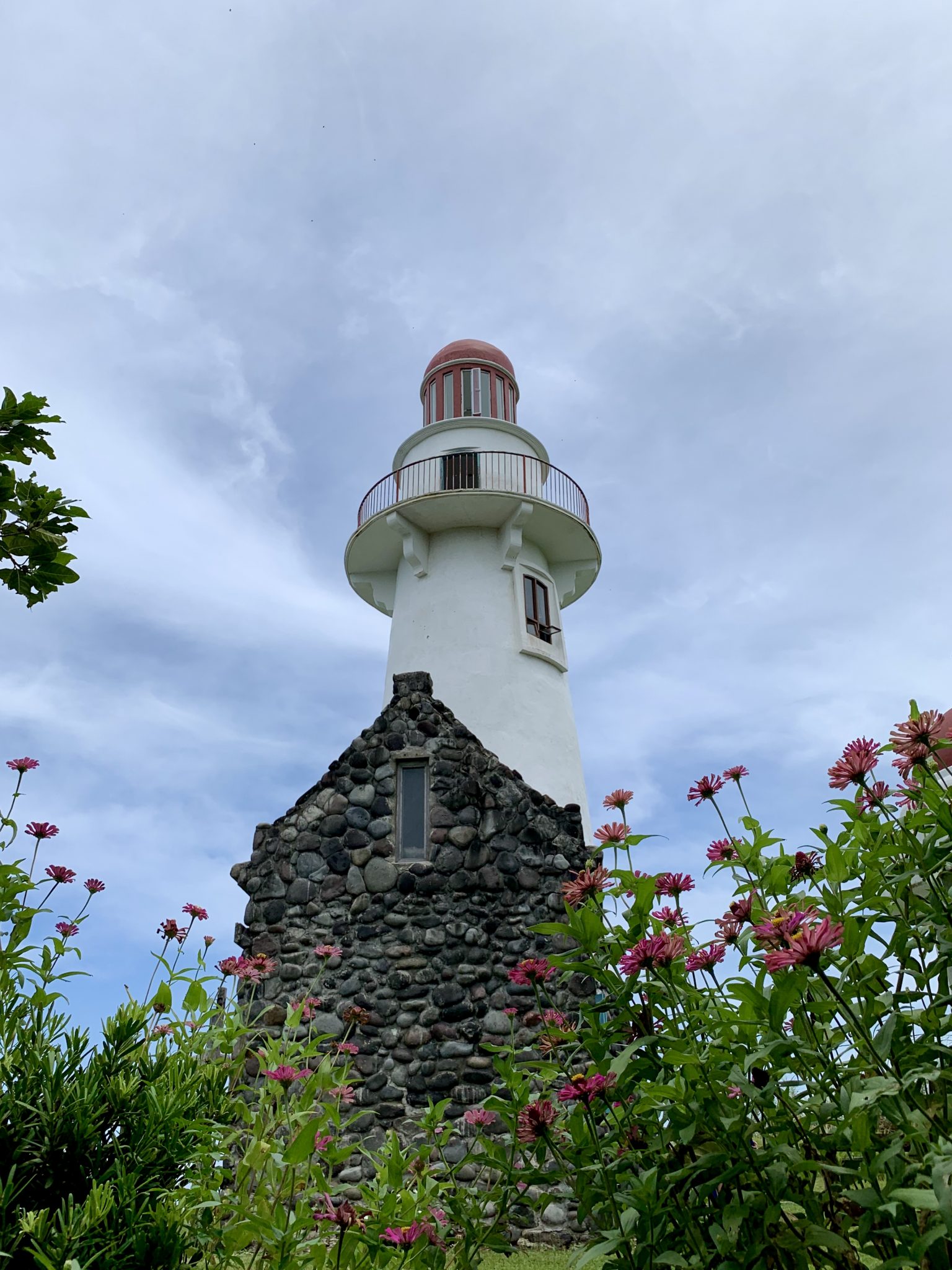 Iconic Batanes lighthouse against a bright blue sky
