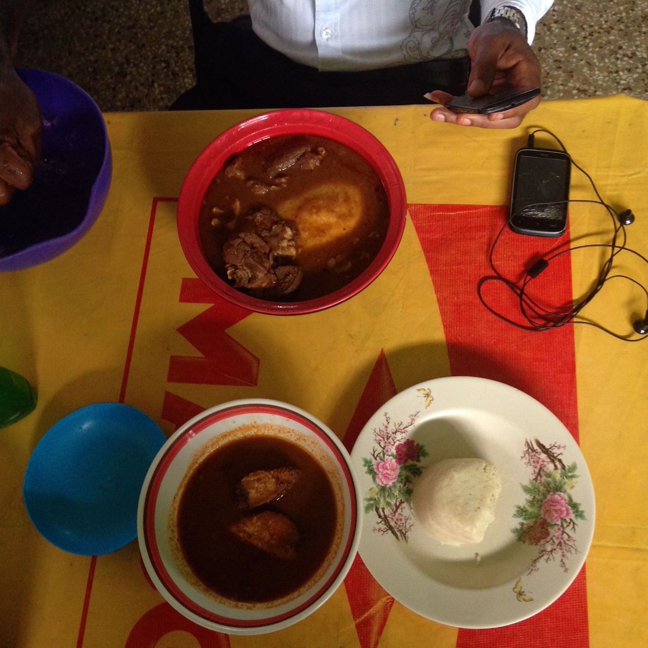 Bottom: banku, fish and light soup Top: fufu, goat and soup (unknown)
