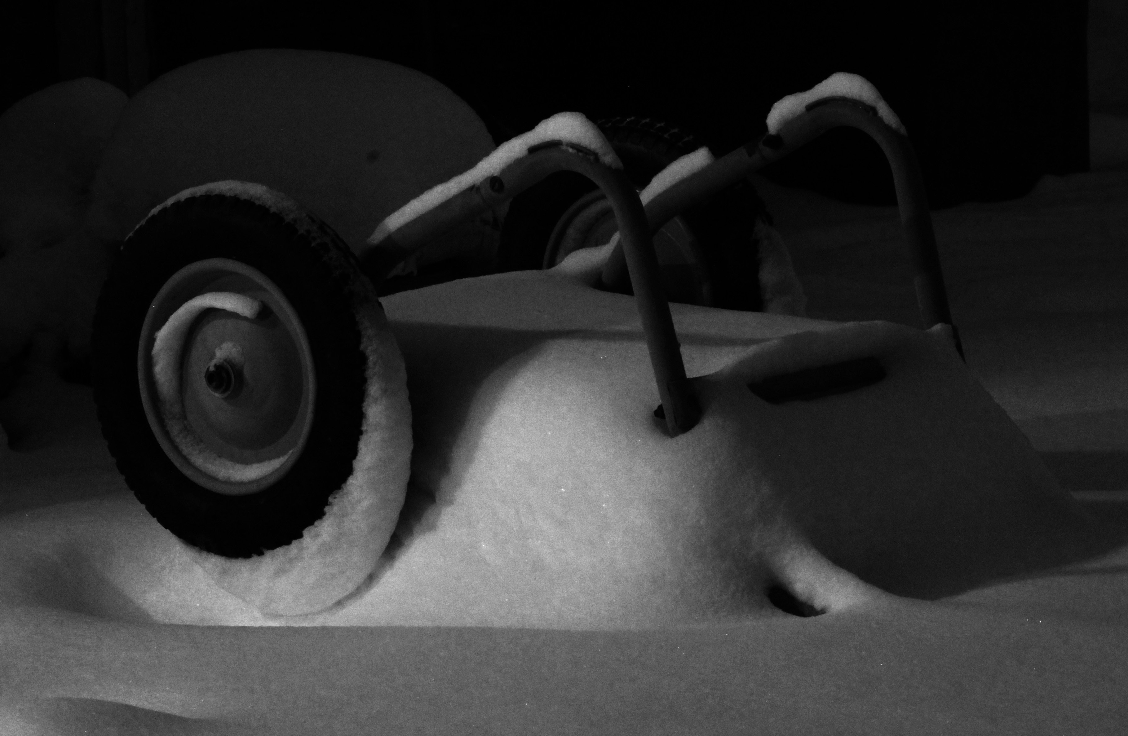 photo of wheelbarrow covered in snow