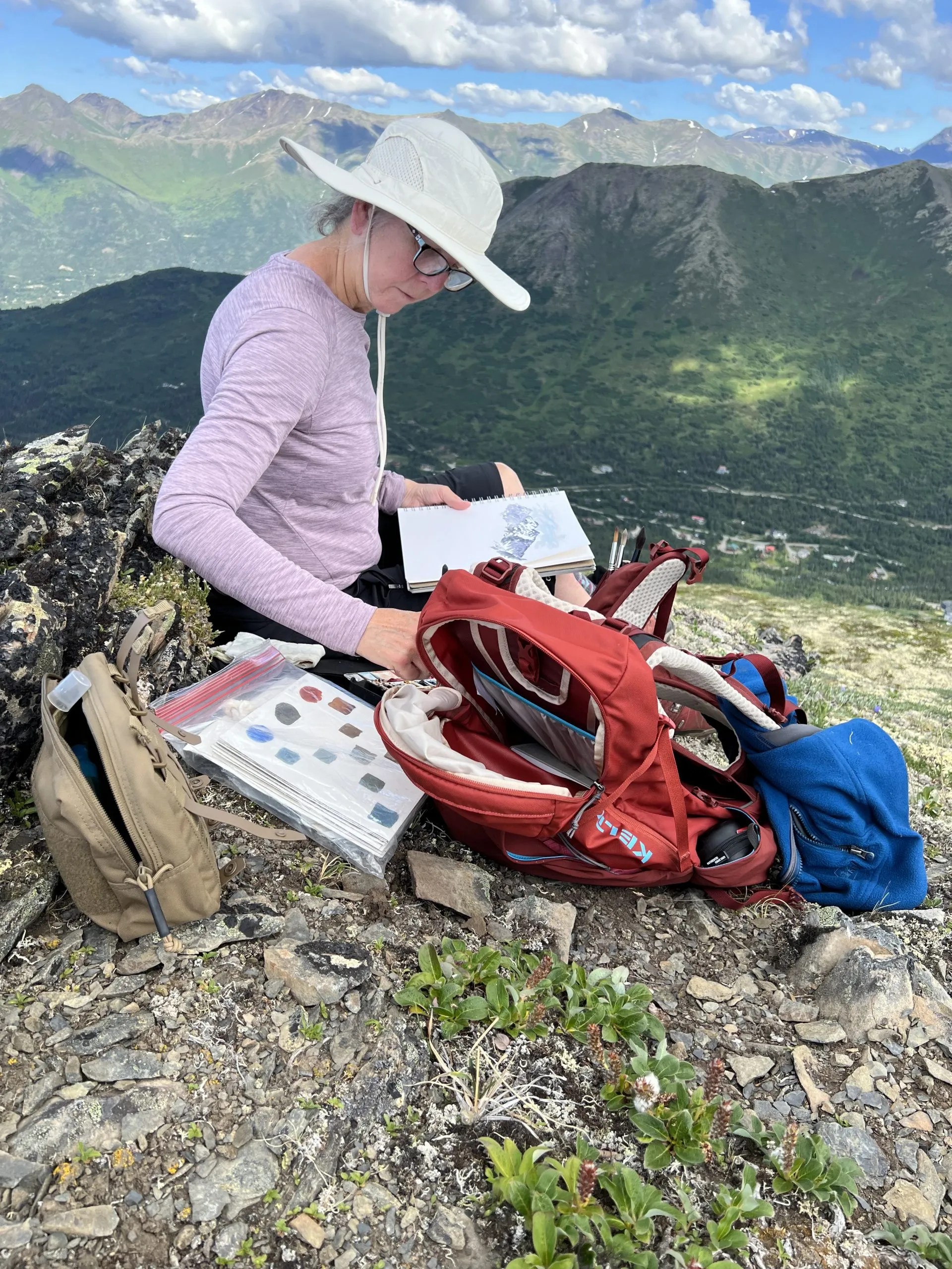 photograph of Sandy McDermott nature journaling in Alaska