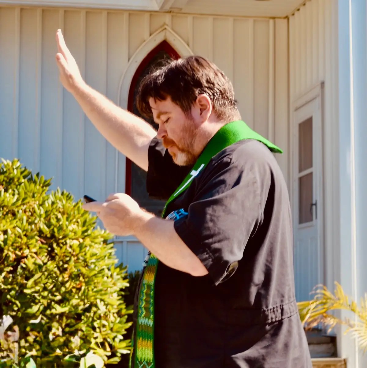 A priest holding his hand up in prayer