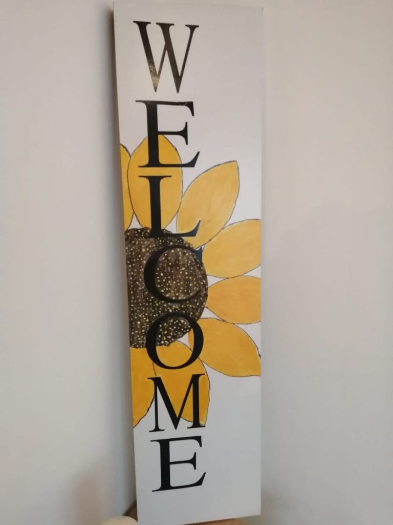 A wooden sign that says welcome