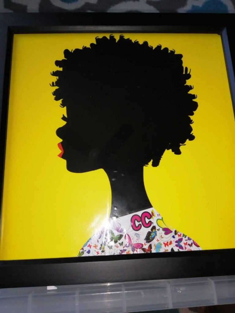 picture frame of a black lady with red lipstick