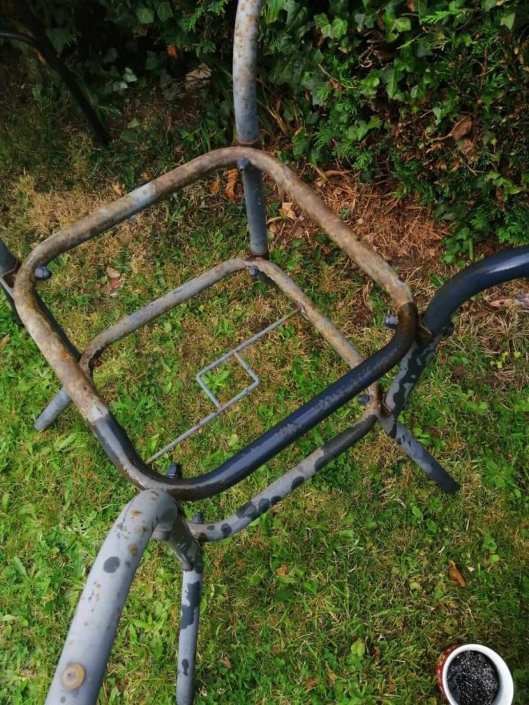 a rusty old metal table base