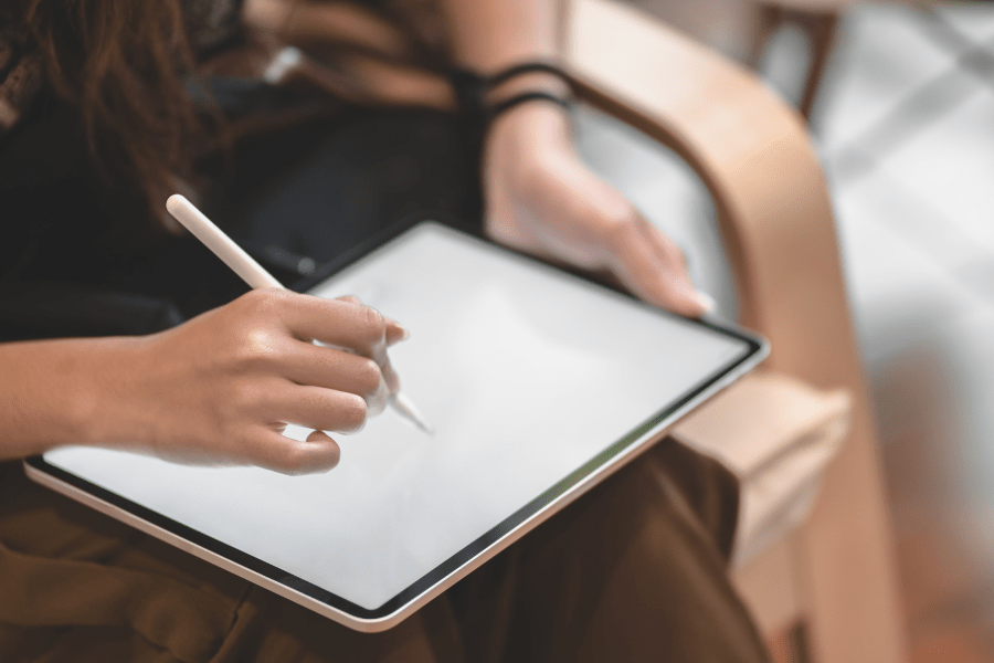 person drawing on a tablet