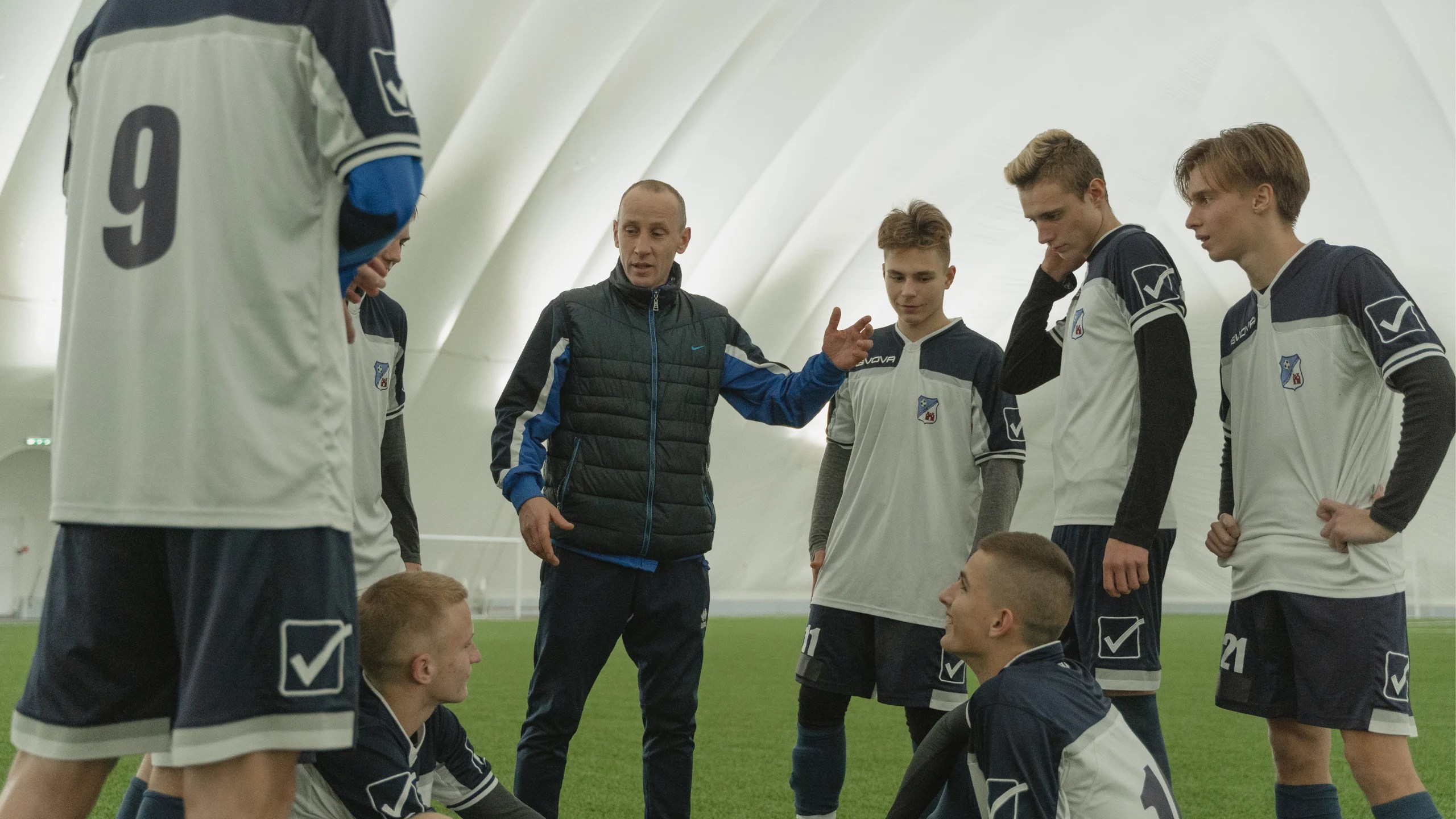 A manager talking to his players.