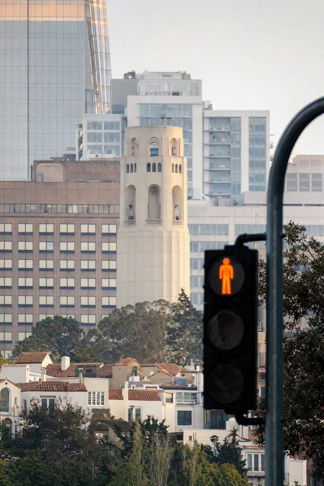 A vertical photo of a city street with a traffic light.