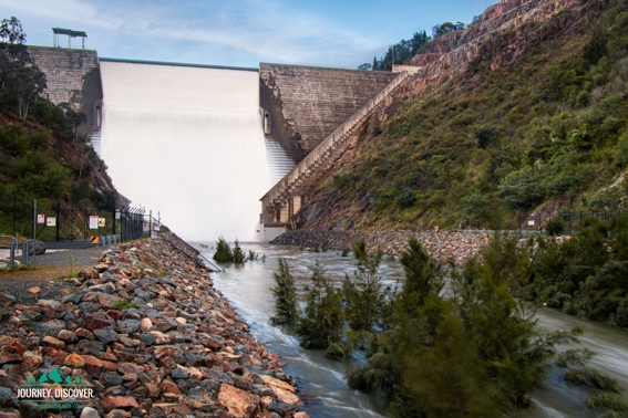 water spilling over the Cotter Dam Wall.