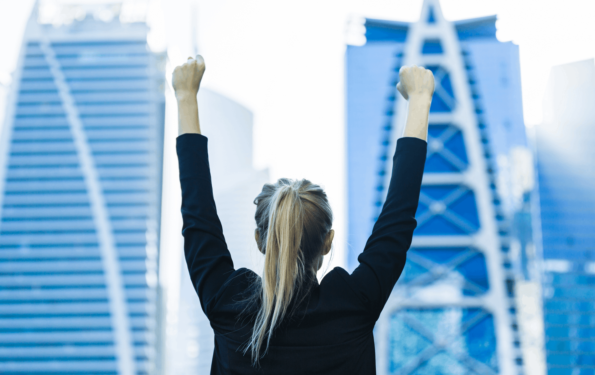 Woman in a city celebrating a promotion