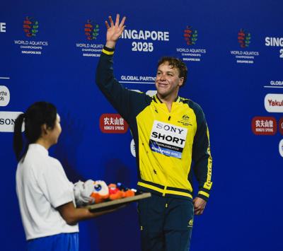 A man on the podium of the world swimming championships in Singapore