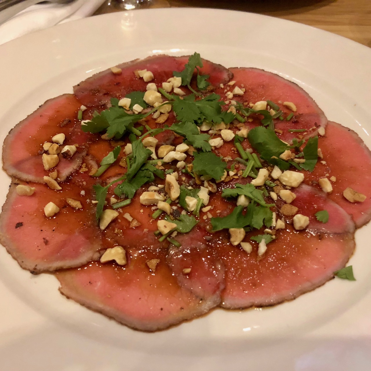 Vietnamese style bison carpaccio, sweet soy and hazelnuts