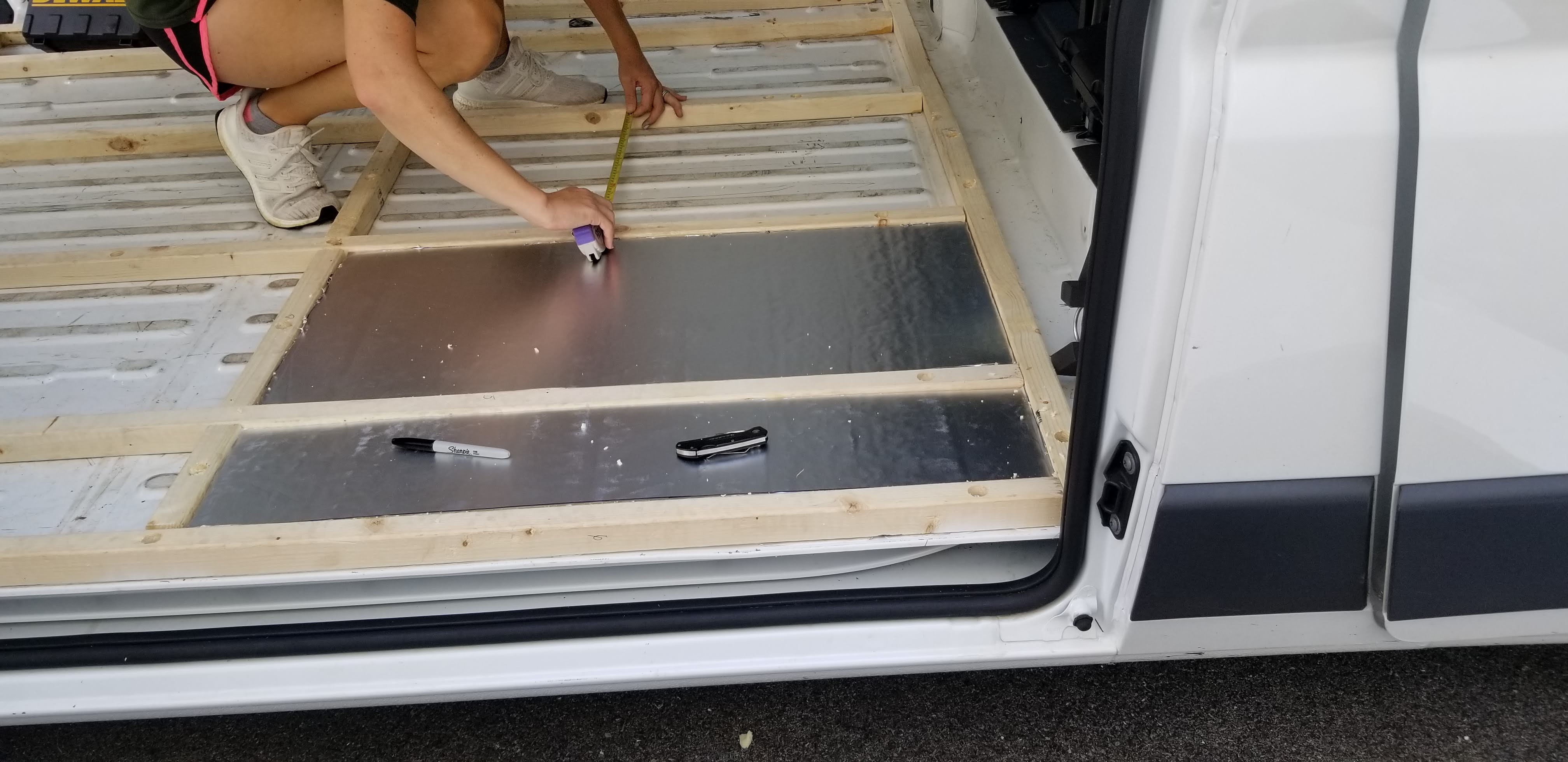 Measuring between the joists so we can cut the PolyISO board to size