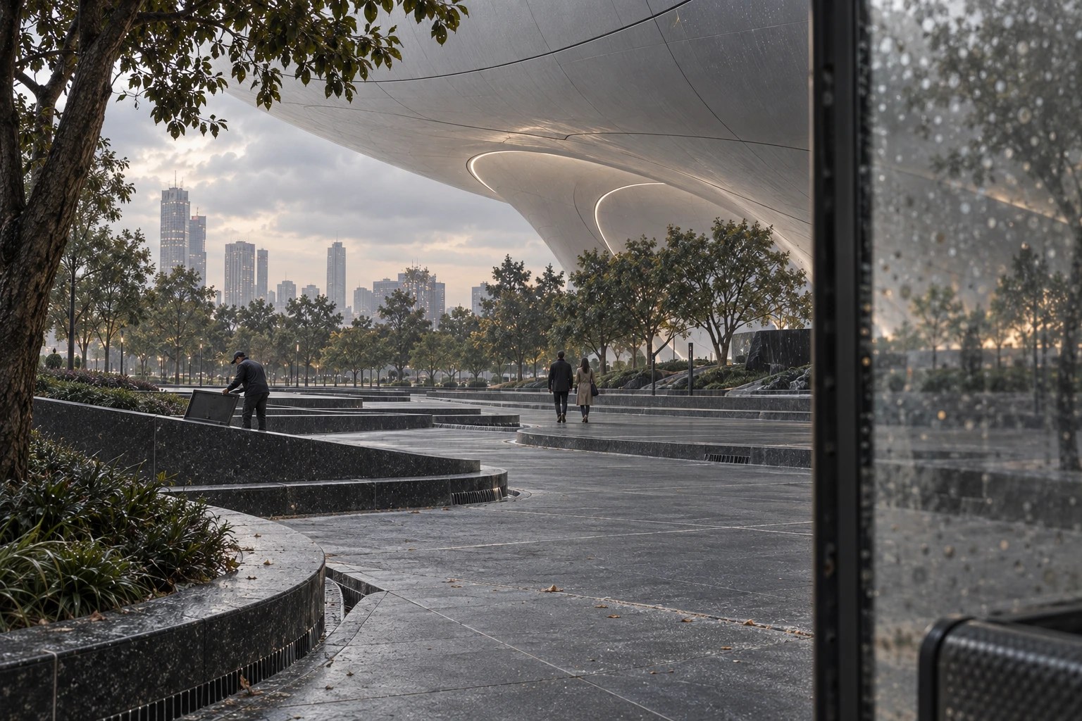 The Urban Cave, Lucas Museum: the first drops. The plaza begins to change before the storm becomes visible.