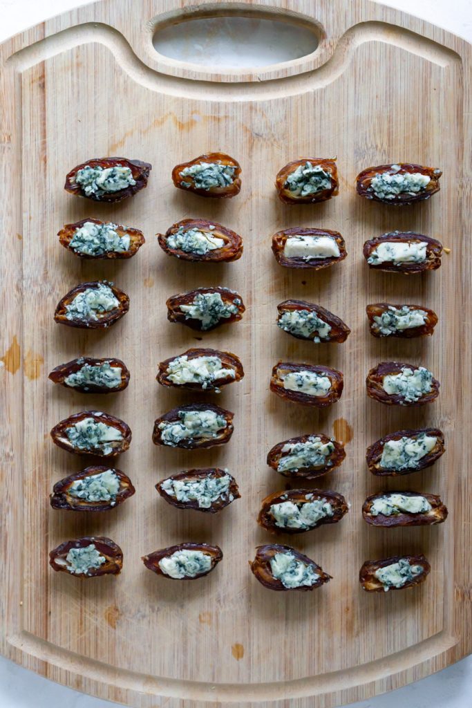 blue cheese stuffed dates on a cutting board