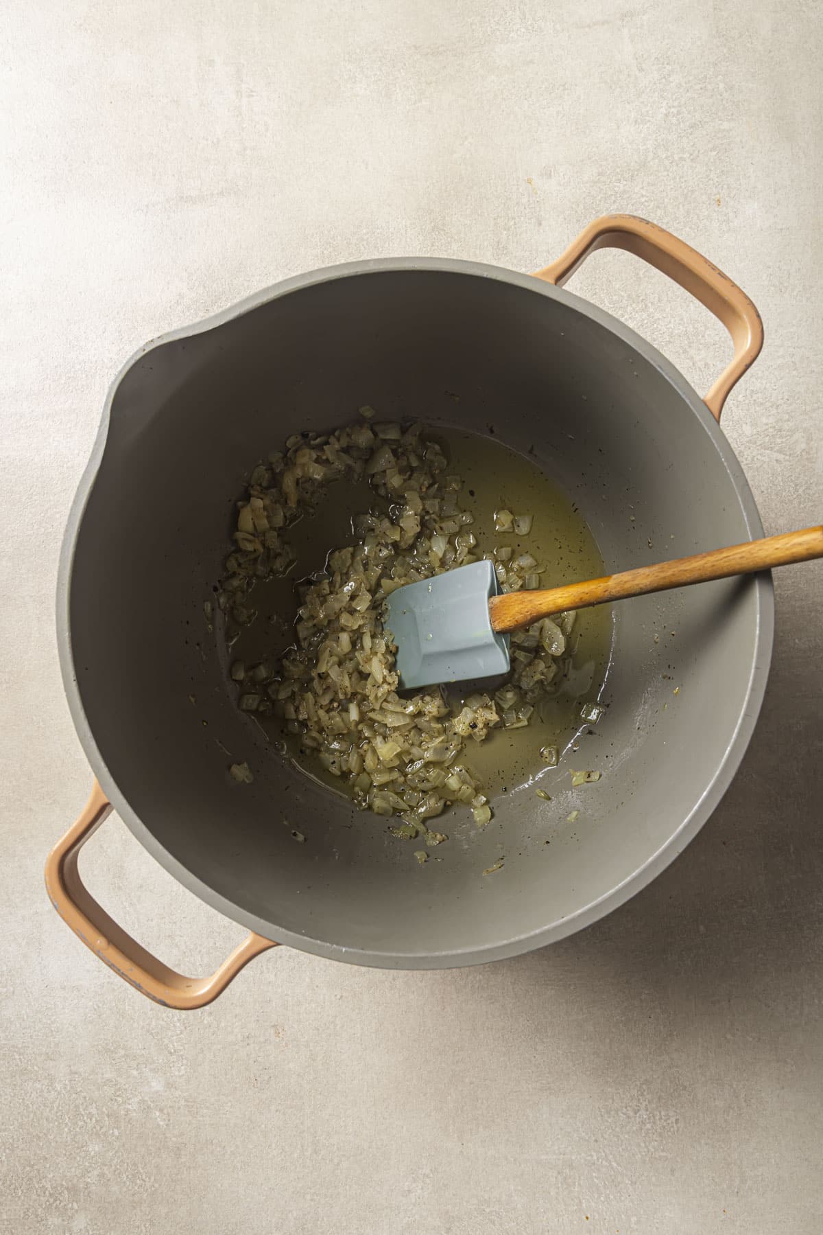 Saut&eacute;ing onion and garlic in a large pot.