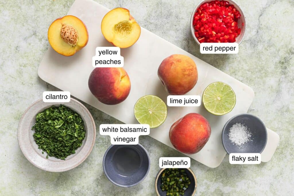 Flat lay of peach salad ingredients on a counter labeled. 