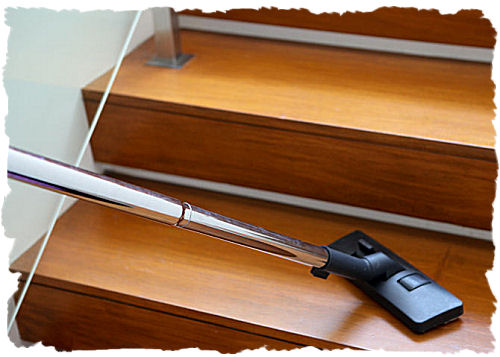 Cleaner vacuuming a home stairway
