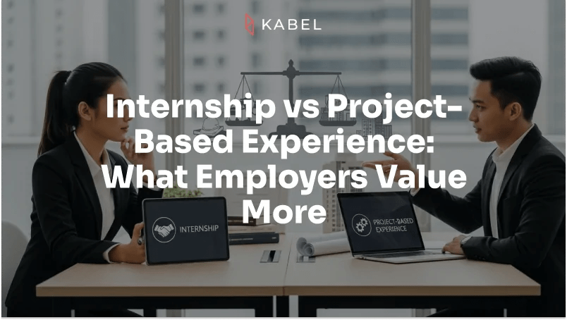Two people in business attire sit across a desk with laptops displaying "Internship" and "Project-Based Experience," engaging in a discussion about employer preferences regarding internship vs project experience. Kabel Job Platform