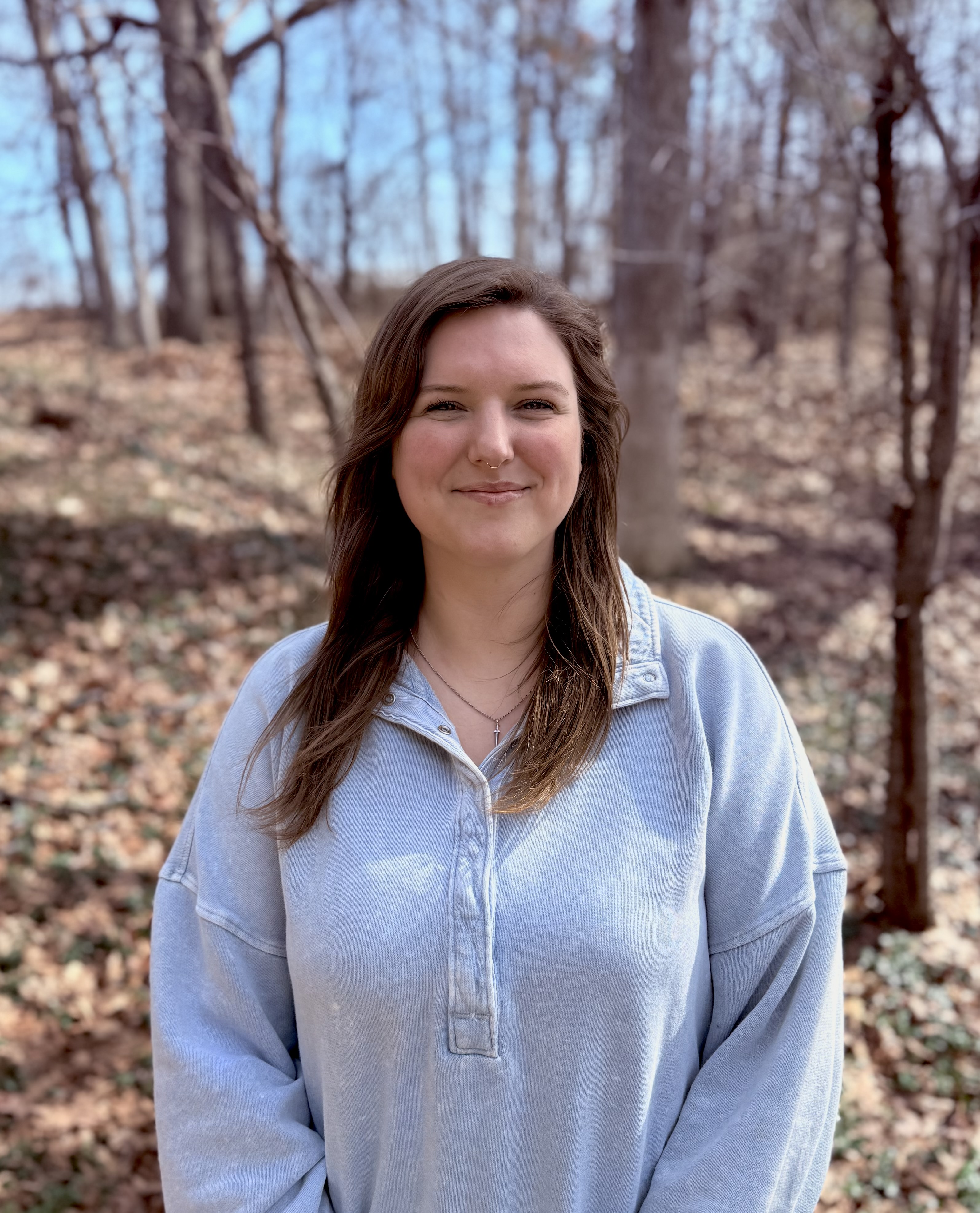 carly applebey looking at the camera with an autumnal background