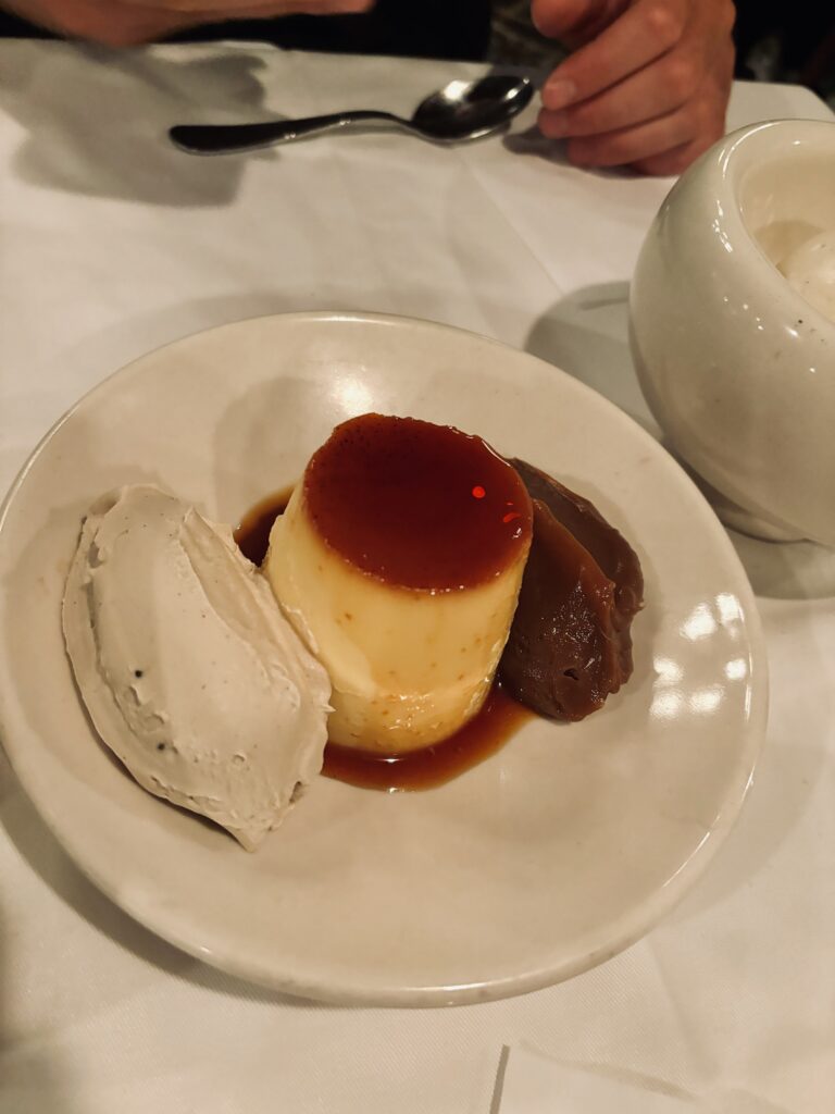From the Menu at Parrilla Don Julio Buenos Aires: Flan is served on a white plate with a whip of cream and a spoonful of dulce de leche.