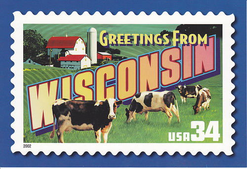 postcard stamp showing cows, barn, and "Greetings from Wisconsin"