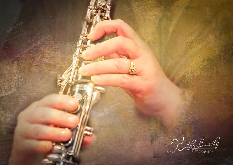 A closeup of hands playing a clarinet.
