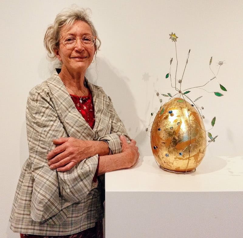 Katie Sabry standing next to an artwork