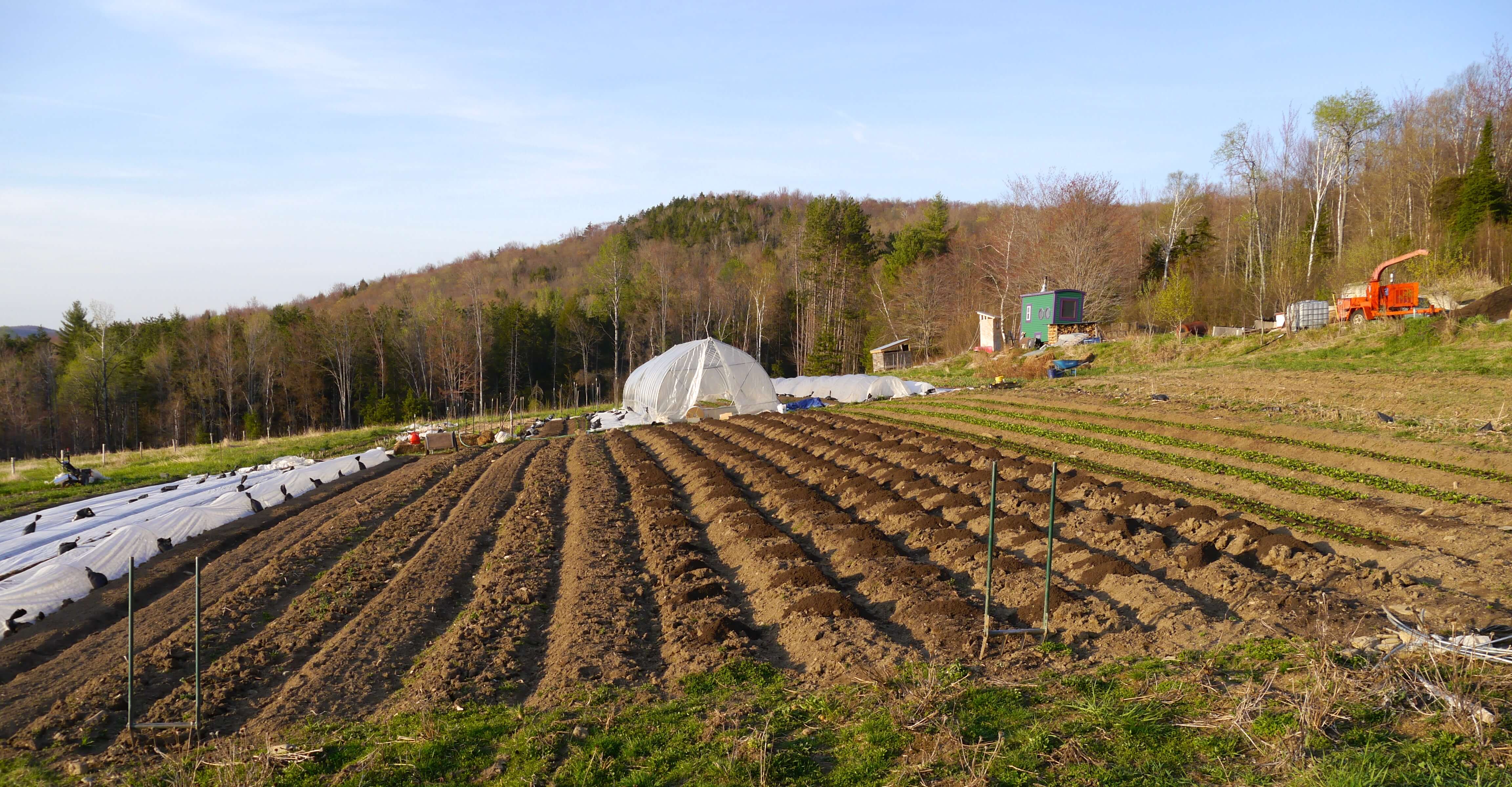 Preparing beds for planting on our organic farm; day jobs help us invest in growing the farm