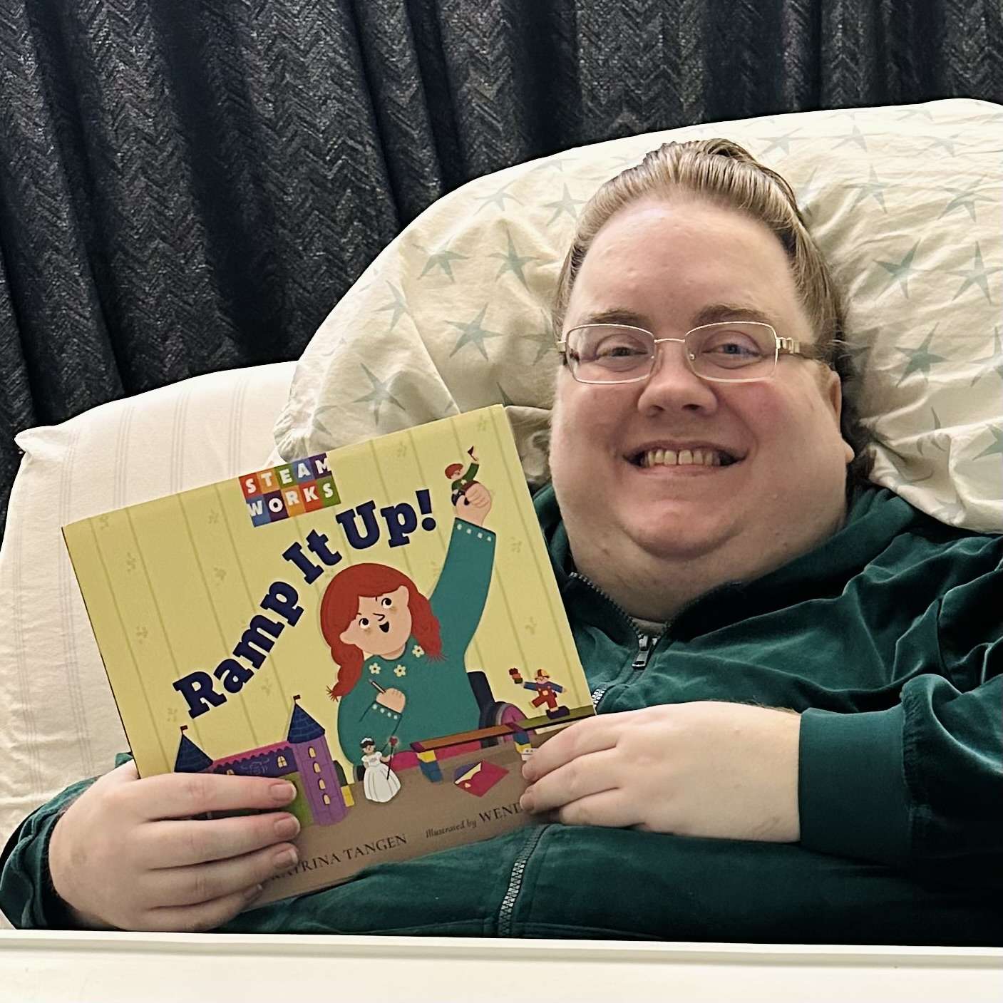 Katrina holding picture book titled “Ramp it Up!”