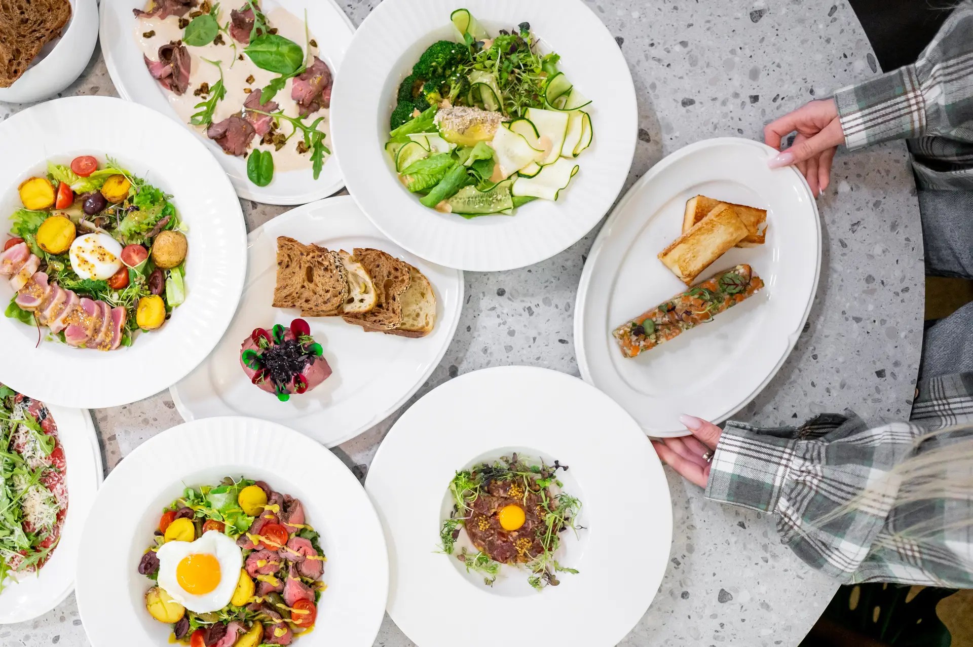 A top view of an elegant dining table featuring various gourmet dishes.
