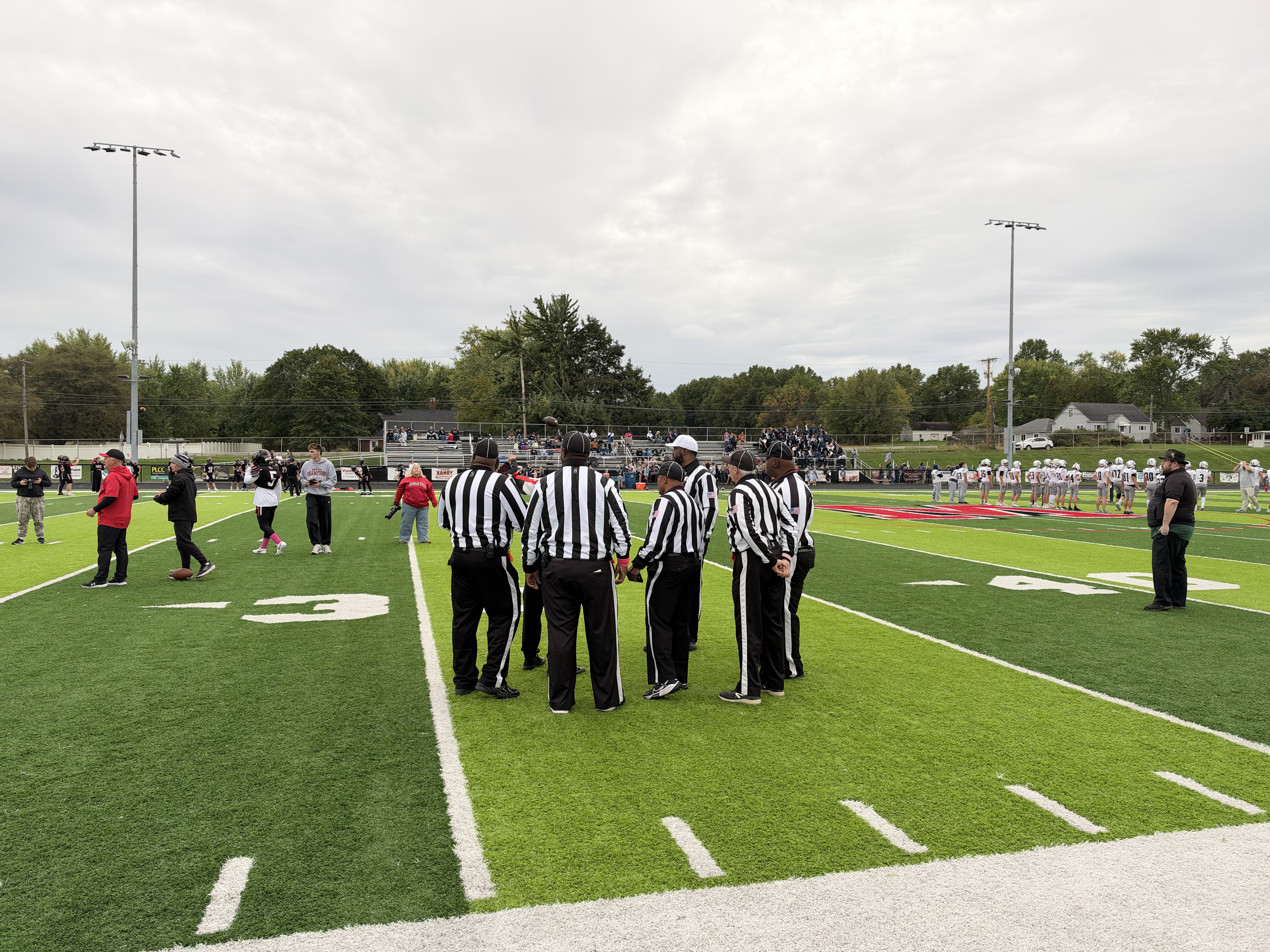 Referees doing a coin toss before football game