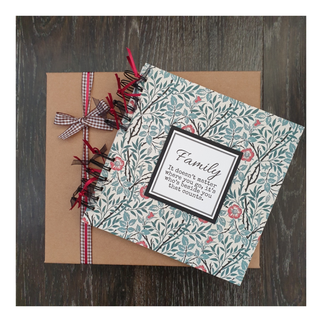 Scrapbook with gift box with with family text and william morris background design
