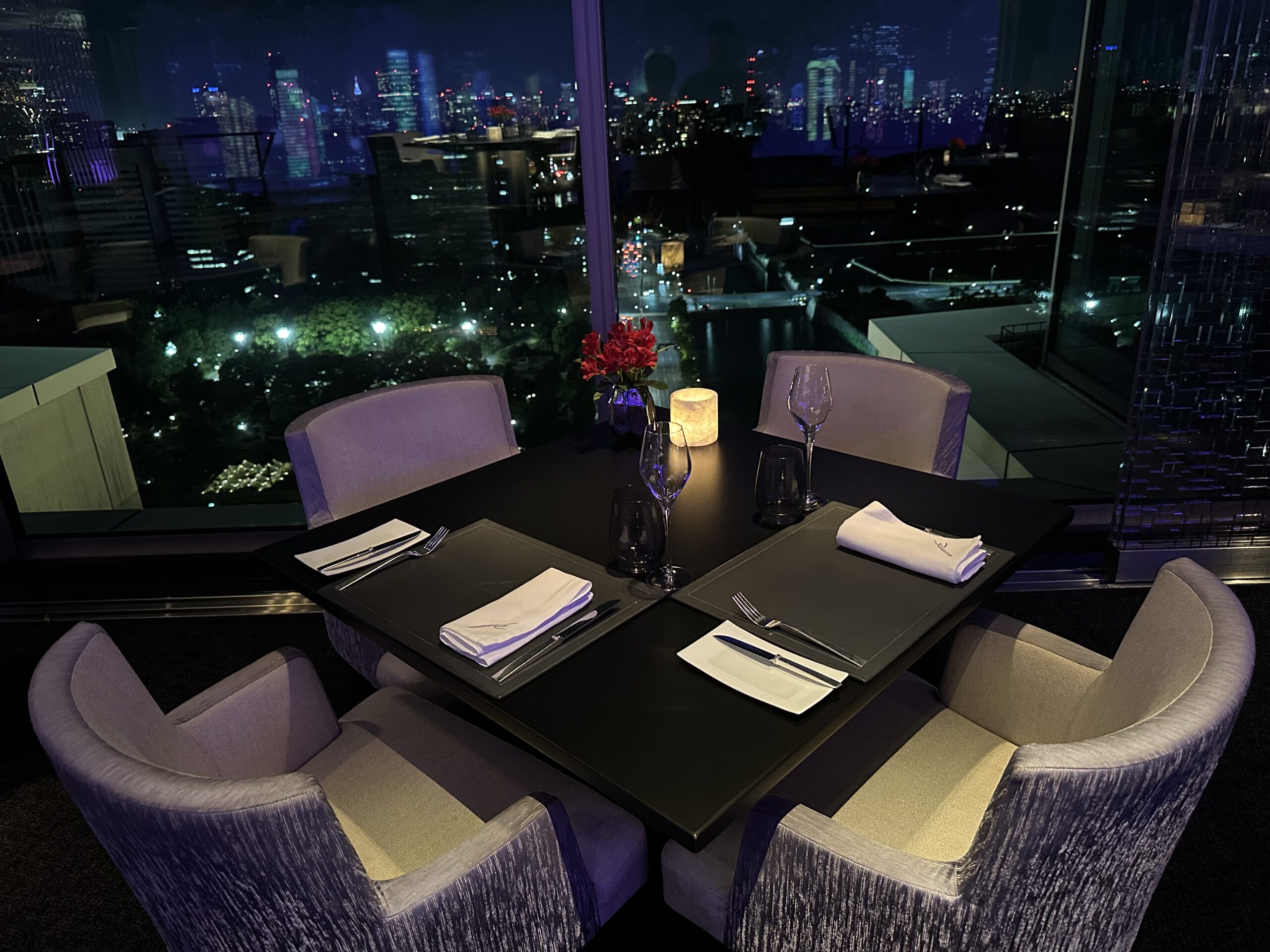 Window-side dining and the Tokyo night skyline at Peter