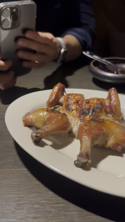 Chicken with golden-brown skin and dark char marks