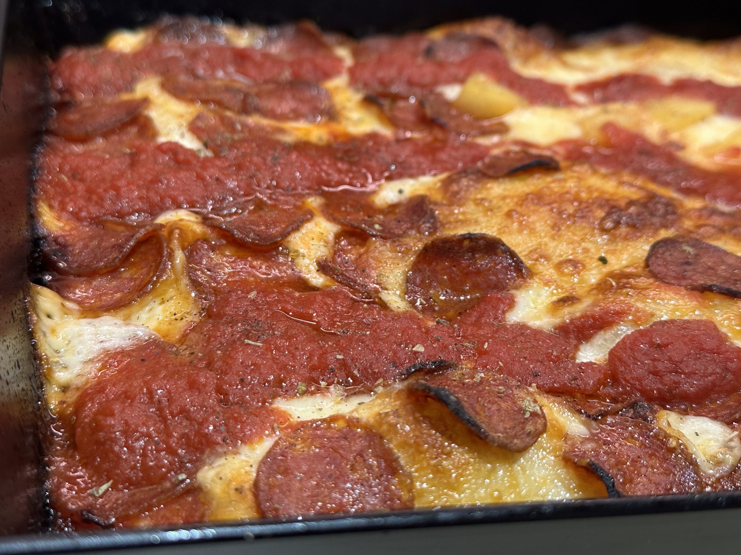 Detroit style pepperoni pizza in a Detroit style baking pan.