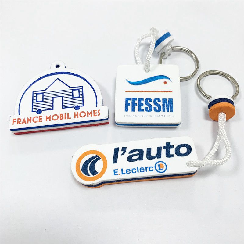 A set of different colored and shaped EVA foam floating keychains, including a red, white, and blue circular one.