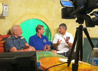#News: Astronauts Aldrin and Gernhardt in Underwater Habitat as Part of Classroom Under The Sea #News: Astronauts Aldrin and Gernhardt in Underwater Habitat as Part of Classroom Under The Sea - A group of people standing around a table - CitizenM
