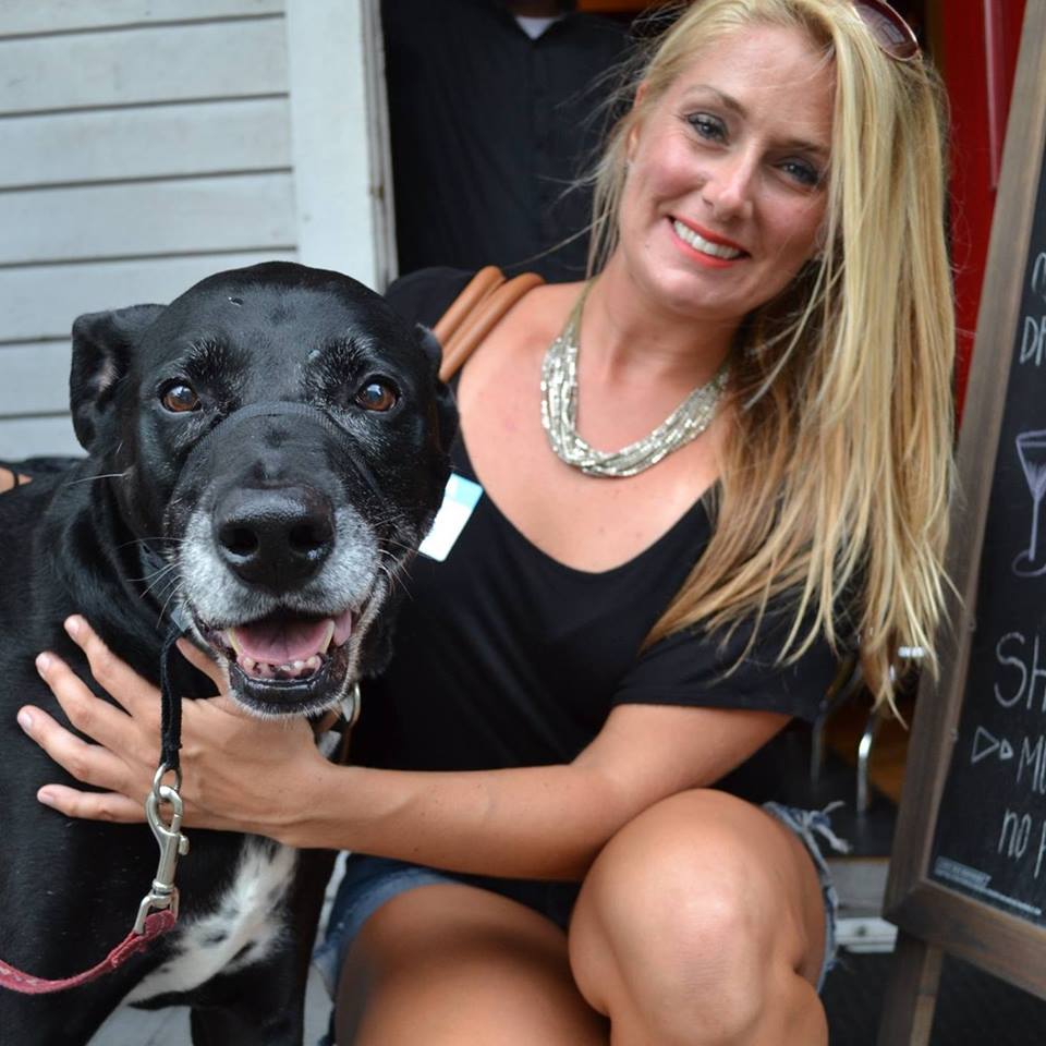 You “CAN” Buy Me Love Date Auction - A woman holding a dog posing for the camera - Dog breed