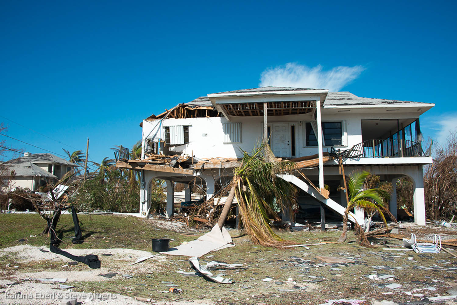 Area looks like a ‘blast zone’ - A group of lawn chairs sitting on top of a building - House