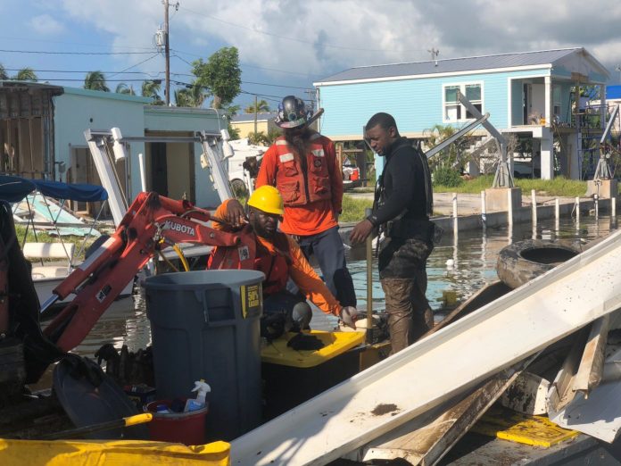 KW4 Canal cleanup begins in all areas - A group of people standing on a boat - Key West