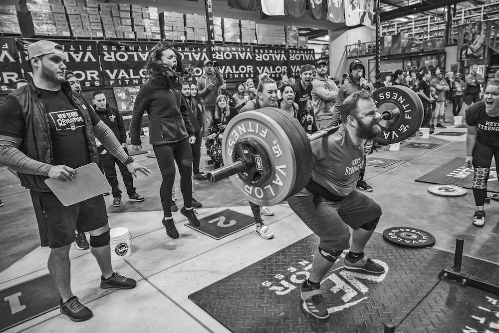Local athletes conquer fitness competition - A person riding a skate board on a city street - Keys Strength and Conditioning