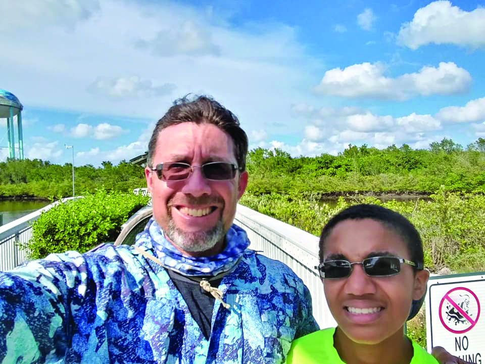 Familiar Faces of Fathers from Key West, Marathon, and the Upper Keys - A couple of people posing for the camera - Middle School Spelling Bee