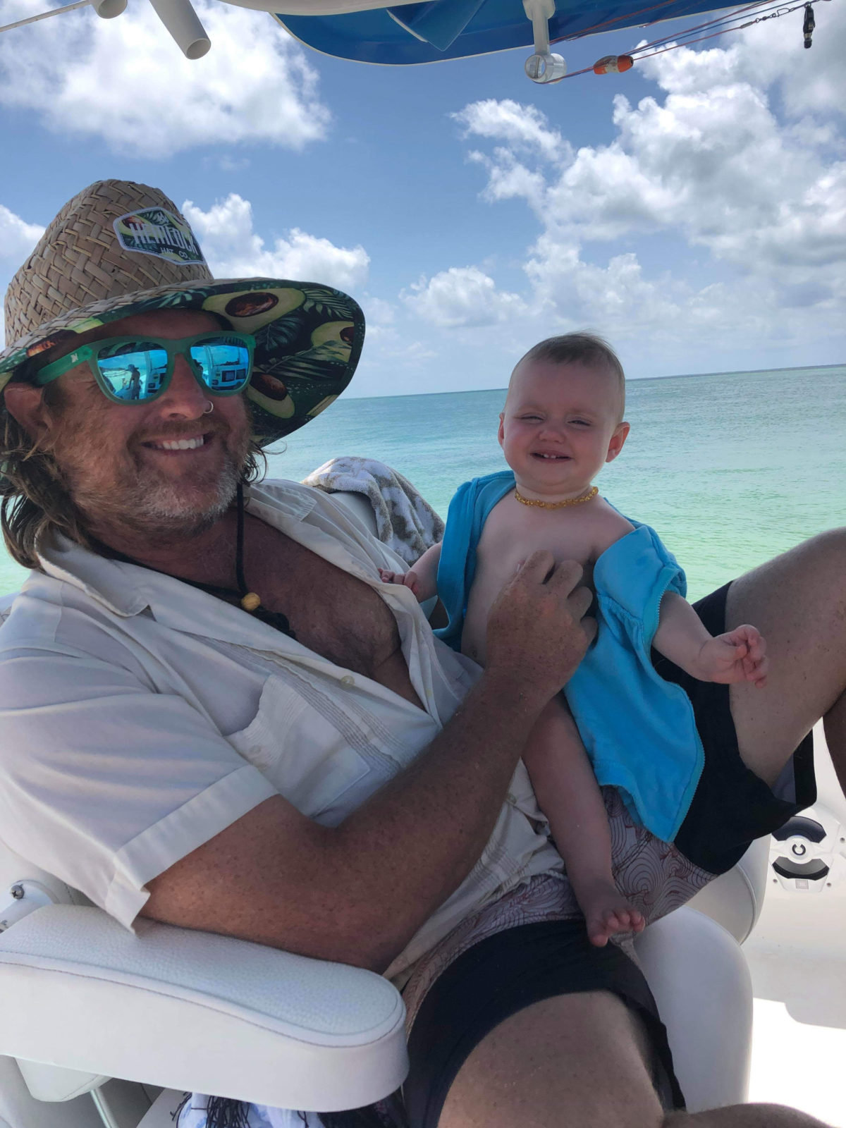 Familiar Faces of Fathers from Key West, Marathon, and the Upper Keys - A person holding a baby in a body of water - My father gave me the greatest gift anyone could give another person, he believed in me.